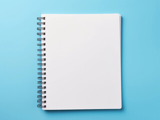 Blank spiral notebook over blue background flat lay 