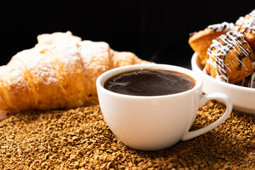 A cup of instant coffee granules and scones. Beautiful and delicious breakfast.