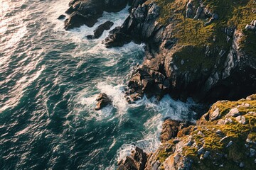 Obraz premium Nature's untamed power on full display as waves relentlessly crash against the rugged coast, framed by towering mountains and a cape jutting into the vast ocean