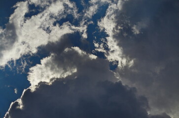 Fototapeta na wymiar Background of rainy fluffy clouds floating on a bright blue sky, Sofia, Bulgaria 