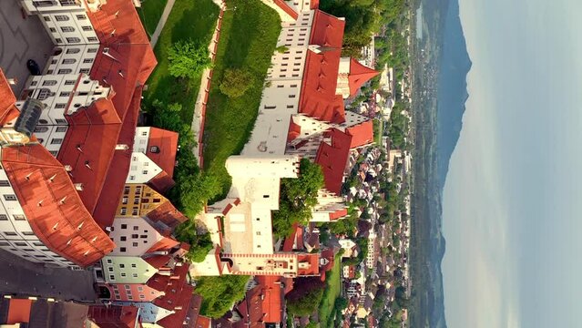 Aerial view over the medieval town Fussen, river and countryside and mountain, Germany. Aerial vertical, vertical video background.