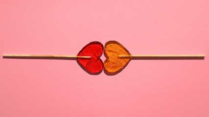 Snacks concept, two lollipops in the shape of a heart