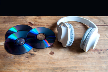 headphones and cd on a wooden background