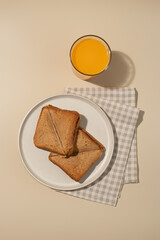Sandwich and juice on a beige background