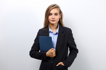 Young caucasian female secretary holding a tablet on a light background with copy space