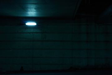 front view of dark tunnel with blue light, no people