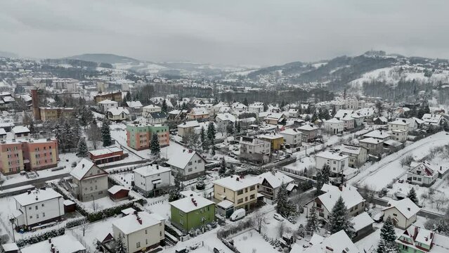 Limanowa, Poland - Aerial drone footage of residential houses in European town covered with snow