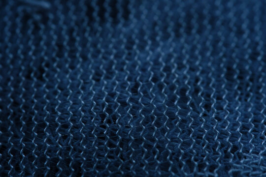 Abstract macro image of fabric in dark tones.