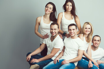 Happy together concept. Group portrait of healthy boys & girls in white t-shirts, sleeveless shirts...