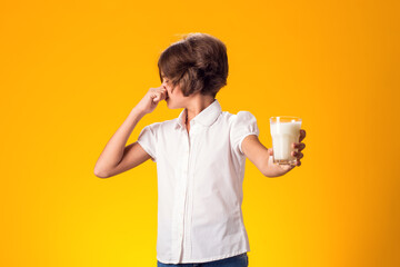 Girl with glass of milk doesn't like it. Dairy Intolerant person. Lactose intolerance, health care...