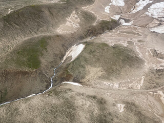 Aerial view of Alaskan tundra. In physical geography, tundra is a type of biome where tree growth is hindered by frigid temperatures and short growing seasons.  © EWY Media