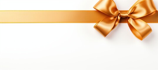Golden ribbon bow with long straight piece for festive banner, isolated on white background