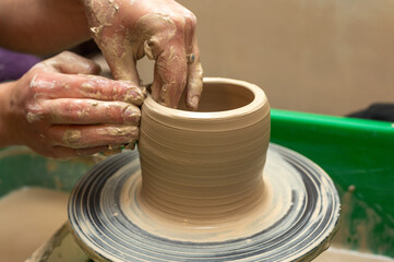 Clay, pottery or hands in designer workshop working on an artistic cup or mug mold in small business studio. Hand of creative artist or worker manufacturing handicraft products in sculpture