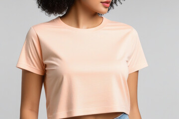 Woman in peach fuzz colored tshirt, can be used for design, mock up. The trending color of 2024.