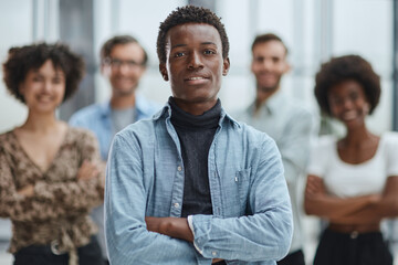 smiling African American business man with executives working in background