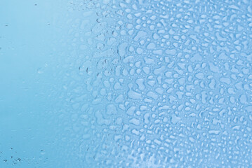 Blue glass with water drops. Wet glass.