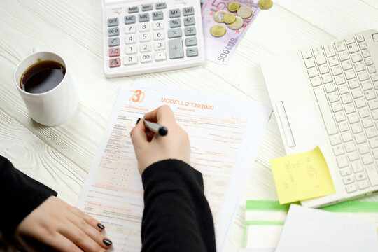 Accountant fill italian tax form Modello 730 individual income tax return in end of tax period. Taxation and paperwork routine in Italy