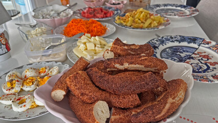 A variety of food and drinks at the Turkish breakfast table. Turkish bagel