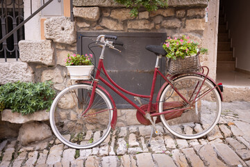 Fototapeta na wymiar The old city of Rovinj, Istria peninsula, Croatia. A bicycle in the historic center with flowers in baskets.