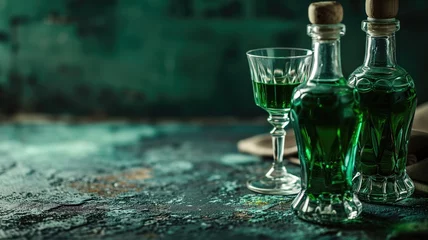 Foto op Plexiglas Two glasses and bottles of green herbal liqueur, absinthe with plants around © Artyom