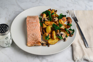 baked salmon  potato wedges , spinach and mushrooms
