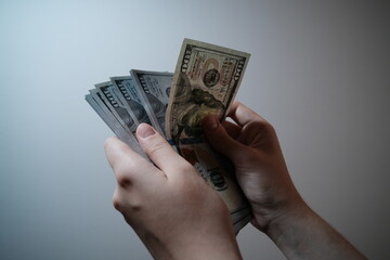 person holding 100 dollar banknotes 