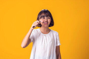 Girl holding magnifier in hand. Education and curiosity concept