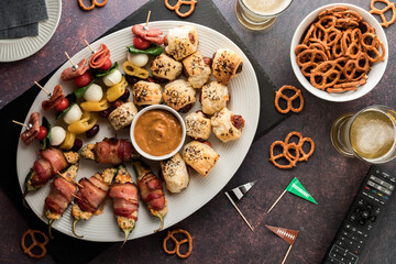 A platter of game day appetizers with beer and pretzels. - obrazy, fototapety, plakaty