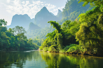 Fototapeta na wymiar Beautiful natural scenery of river in southeast Asia tropical green forest with mountains in background.