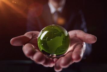 man holding a small green glass ball, generative ai