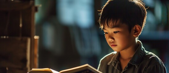 Asian youth with a book