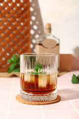 Glass of cold rum on table