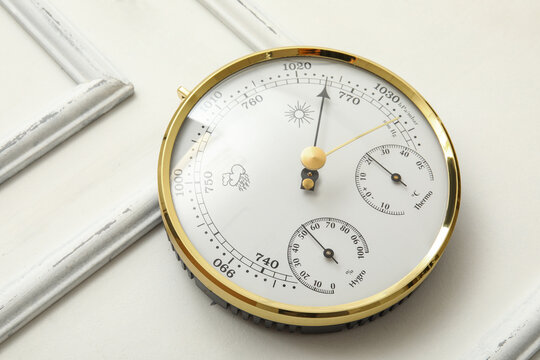 Aneroid barometer on white wooden background