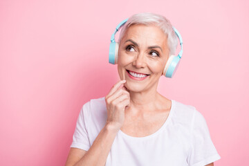 Photo portrait of lovely senior lady headphones look interested empty space wear trendy white...