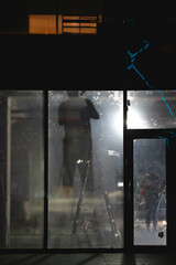 silhouette of a person in the window of a building at night