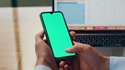 Manager fingers swiping greenscreen mobile at office. Closeup man surfing web