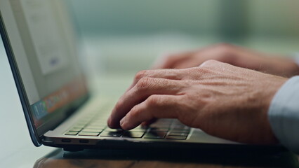 Man hands texting laptop keyboard at office closeup. Unknown businessman working