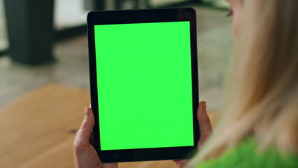 Woman fingers holding greenscreen tab at office closeup. Manager reading tablet