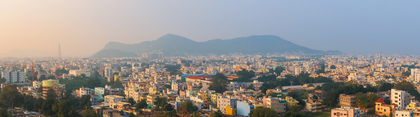 Vijayawada cityscape in India during twilight with tall buildings and colorful homes.