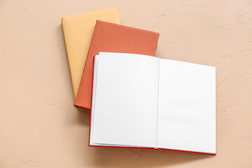 Open book with blank pages on beige background