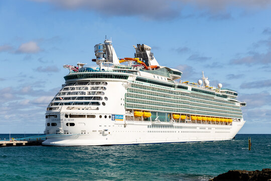 NASSAU, BAHAMAS - OCTOBER 12, 2019: A Royal Caribbean Navigator of the Seas cruise ship while docked at the CocoCay port where people can enjoy the private beach, food, drinks, and activities.