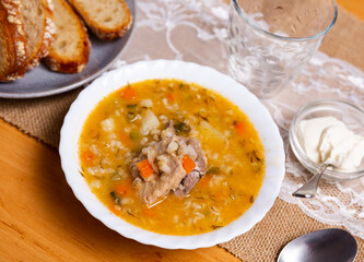National Russian dish is Pickle soup with meat, cooked on the basis of pickled cucumbers and pearl barley