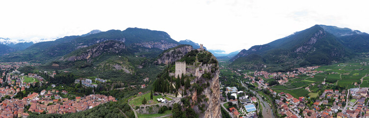 Fototapeta na wymiar Aerial view of Arco village and his Arco castle on high rock view, Sarca Valley, Trentino Alto Adige region of Italy . Arco, Trento, Italy