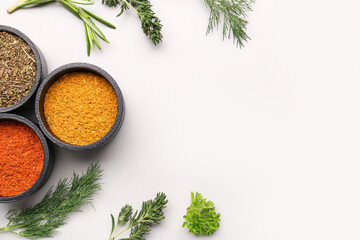 Composition with spices and fresh herbs on light background