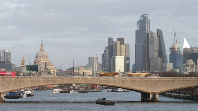 Timelapse of London skyline with traffic going across bridge in foreground