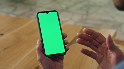 Gesturing man speaking greenscreen phone. Director hand gesticulate telephone