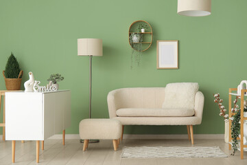 Interior of stylish living room with white sofa, pouf and sideboard