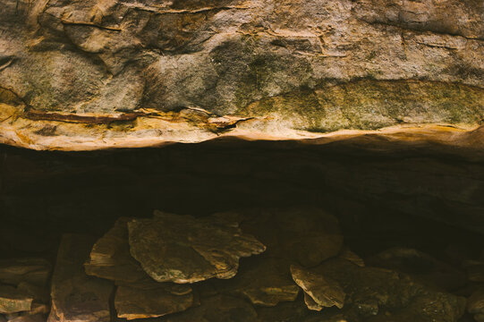 Sun reflects from water into a sandstone cave along the Cumberland Trail in Rock Creek Gorge, Tennessee