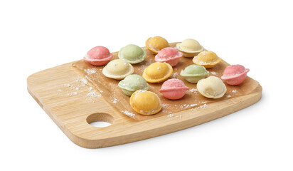 Wooden board with colorful raw dumplings on white background