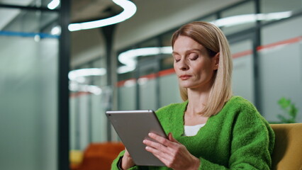 Thoughtful manager working tablet office closeup. Focused woman using computer